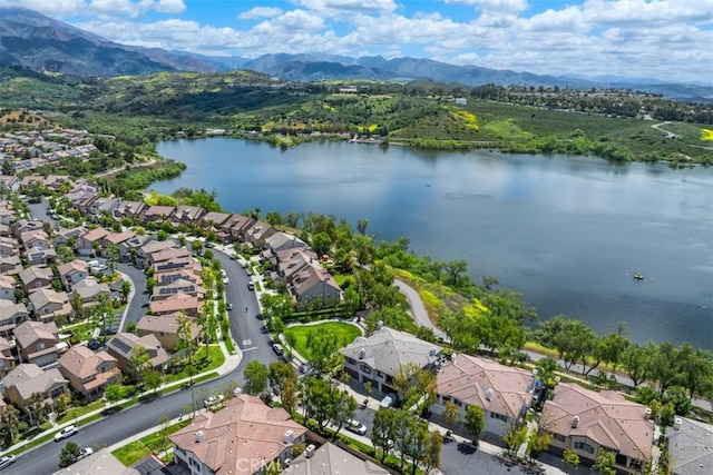 aerial view of residential area featuring a water and mountain view