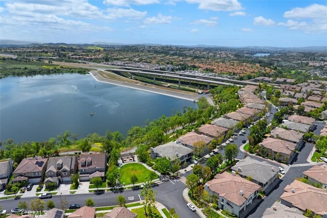 aerial view of property and surrounding area with nearby suburban area and a nearby body of water