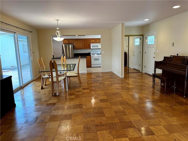 7940 Lena Ave, West Hills, CA 91304 - kitchen with decorative light fixtures, dark countertops, brown cabinets, recessed lighting, and white appliances
