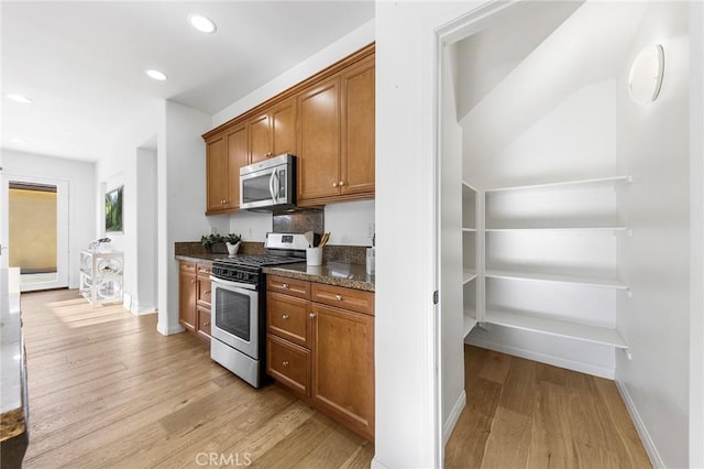 6410 Eucalyptus Ave, Chino, CA 91710 - kitchen with appliances with stainless steel finishes, brown cabinetry, recessed lighting, baseboards, and light wood-type flooring