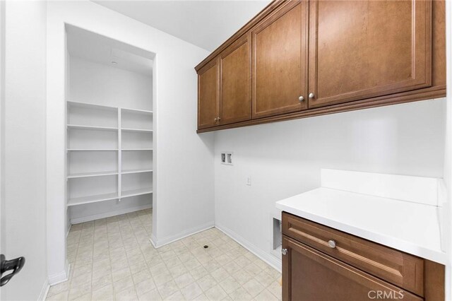 6410 Eucalyptus Ave, Chino, CA 91710 - washroom with light floors, hookup for a washing machine, cabinet space, and baseboards