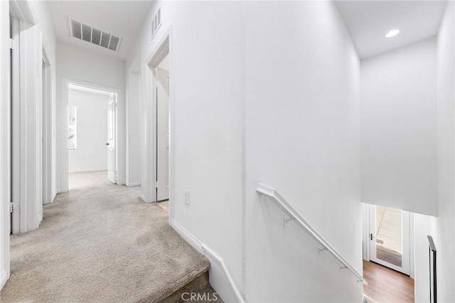 6410 Eucalyptus Ave, Chino, CA 91710 - hallway with carpet floors, baseboards, an upstairs landing, and visible vents