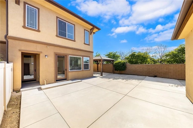 6410 Eucalyptus Ave, Chino, CA 91710 - rear view of house with a gazebo, a fenced backyard, stucco siding, and a patio