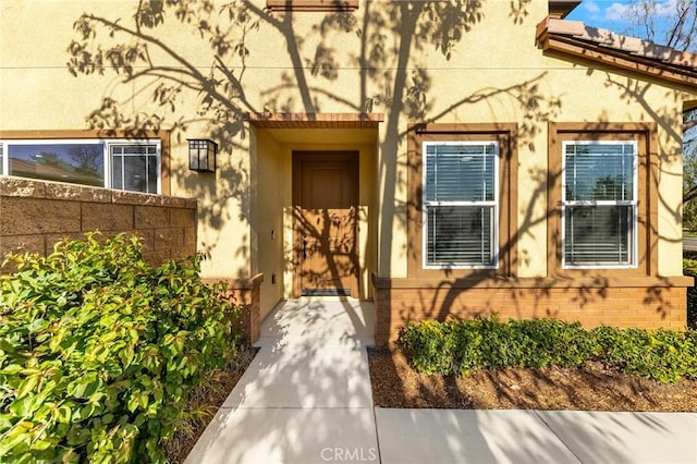 6410 Eucalyptus Ave, Chino, CA 91710 - view of exterior entry featuring brick siding, stucco siding, and fence