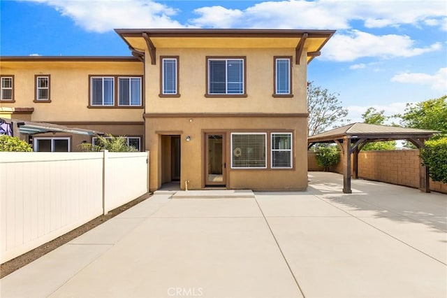 6410 Eucalyptus Ave, Chino, CA 91710 - back of property with a gazebo, a patio area, stucco siding, and fence private yard