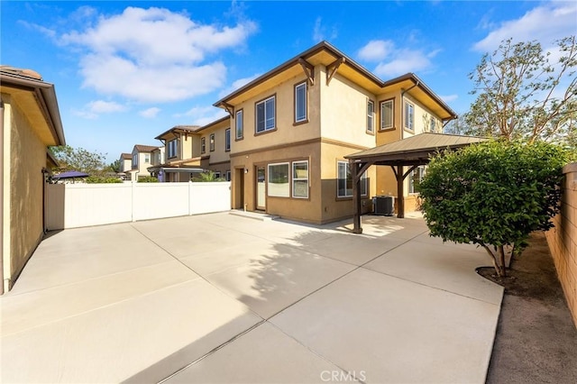 6410 Eucalyptus Ave, Chino, CA 91710 - view of side of home featuring a gazebo, central AC, a fenced backyard, a patio, and stucco siding