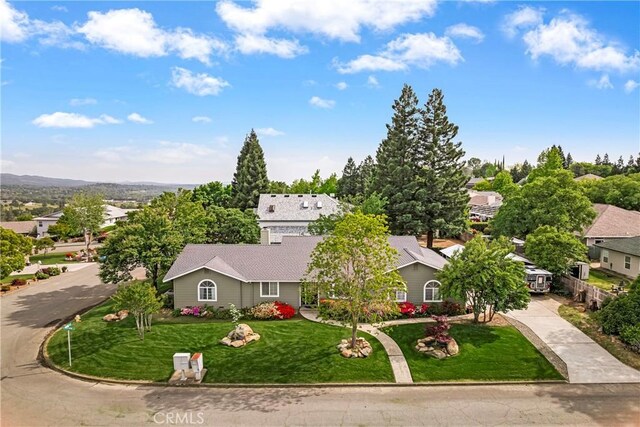 view of front of property with driveway, a residential view, and a front yard