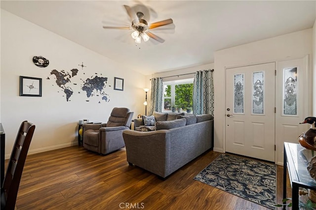 living room with dark wood-type flooring, baseboards, and ceiling fan