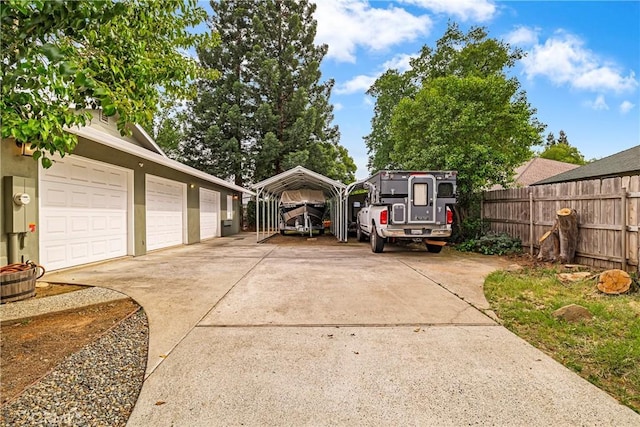 view of yard featuring fence and a carport