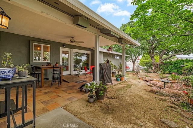 view of patio featuring fence and ceiling fan