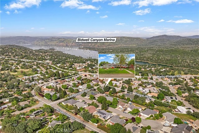 bird's eye view with a water and mountain view
