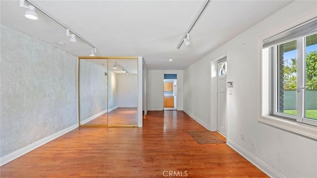 12782 Periwinkle Dr, North Tustin, CA 92705 - unfurnished bedroom with track lighting, wood finished floors, and baseboards