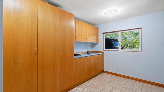 12782 Periwinkle Dr, North Tustin, CA 92705 - kitchen featuring baseboards and light countertops
