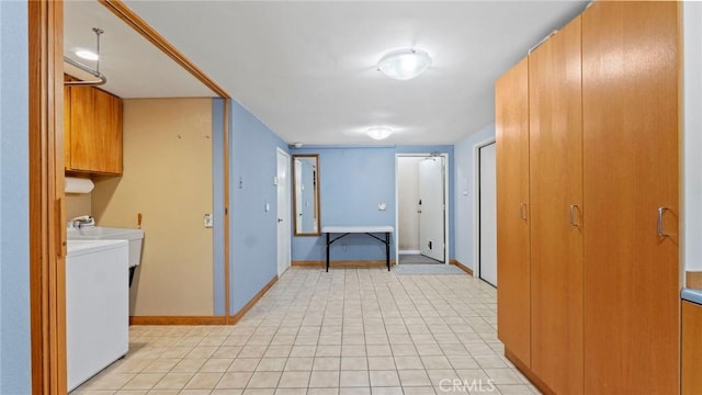 12782 Periwinkle Dr, North Tustin, CA 92705 - laundry area featuring washer / clothes dryer, cabinet space, baseboards, and light tile patterned floors