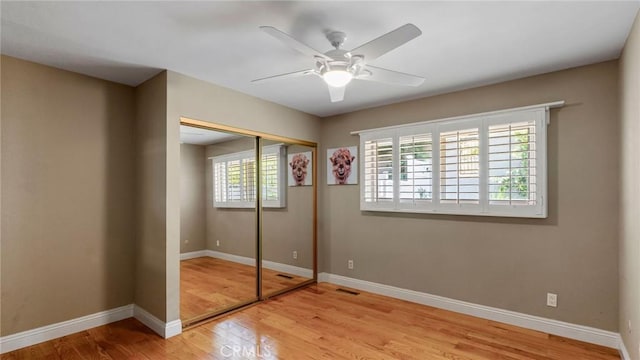 12782 Periwinkle Dr, North Tustin, CA 92705 - unfurnished bedroom featuring wood finished floors, a closet, baseboards, and a ceiling fan
