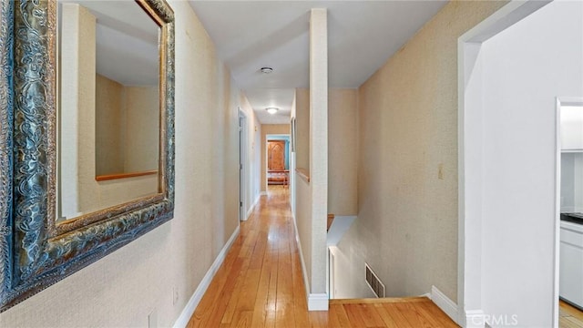 12782 Periwinkle Dr, North Tustin, CA 92705 - hall with wood-type flooring, an upstairs landing, and baseboards