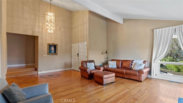 12782 Periwinkle Dr, North Tustin, CA 92705 - living room featuring light wood-type flooring, high vaulted ceiling, and a chandelier