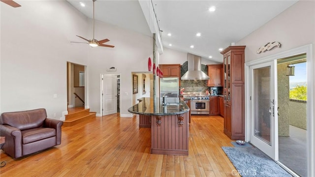 12782 Periwinkle Dr, North Tustin, CA 92705 - kitchen with wall chimney range hood, stainless steel appliances, ceiling fan, vaulted ceiling, and open floor plan