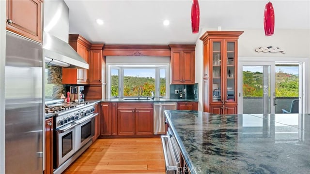 12782 Periwinkle Dr, North Tustin, CA 92705 - kitchen with high end appliances, wall chimney exhaust hood, a sink, backsplash, and glass insert cabinets