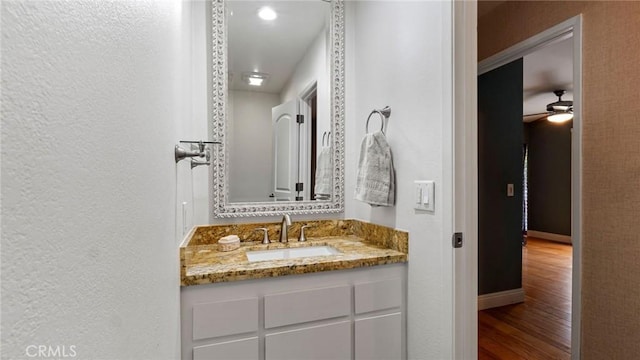 12782 Periwinkle Dr, North Tustin, CA 92705 - bathroom featuring wood finished floors, vanity, ceiling fan, and baseboards
