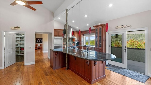 12782 Periwinkle Dr, North Tustin, CA 92705 - kitchen featuring stainless steel built in fridge, light wood finished floors, ceiling fan, a sink, and a breakfast bar area