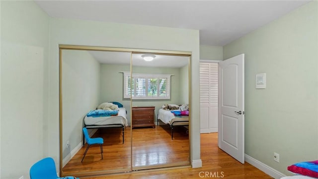 12782 Periwinkle Dr, North Tustin, CA 92705 - bedroom with wood finished floors, a closet, and baseboards