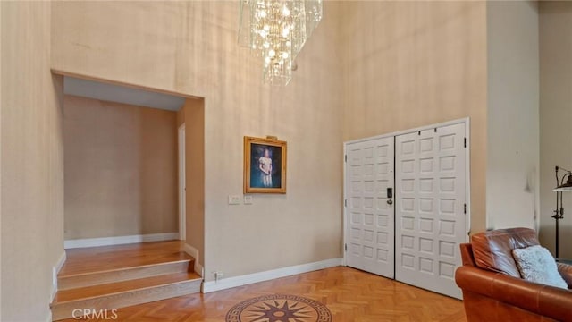12782 Periwinkle Dr, North Tustin, CA 92705 - foyer entrance featuring a high ceiling, a chandelier, and baseboards