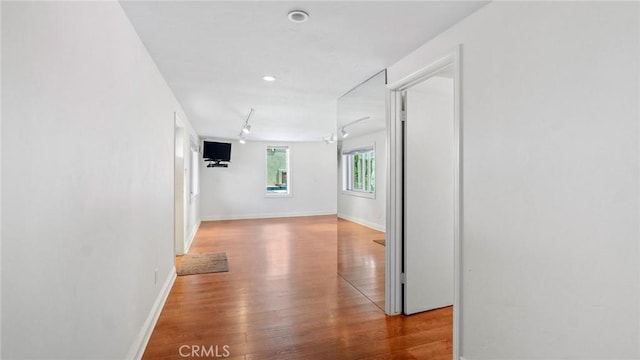 12782 Periwinkle Dr, North Tustin, CA 92705 - hall with wood finished floors, baseboards, and rail lighting
