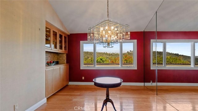 12782 Periwinkle Dr, North Tustin, CA 92705 - dining area with light wood-type flooring, healthy amount of natural light, and a chandelier