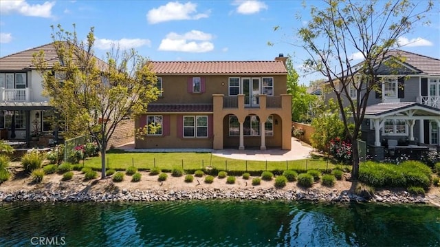 27020 Island Rd, Valencia, CA 91355 - back of house with a chimney, stucco siding, a water view, and a fenced backyard