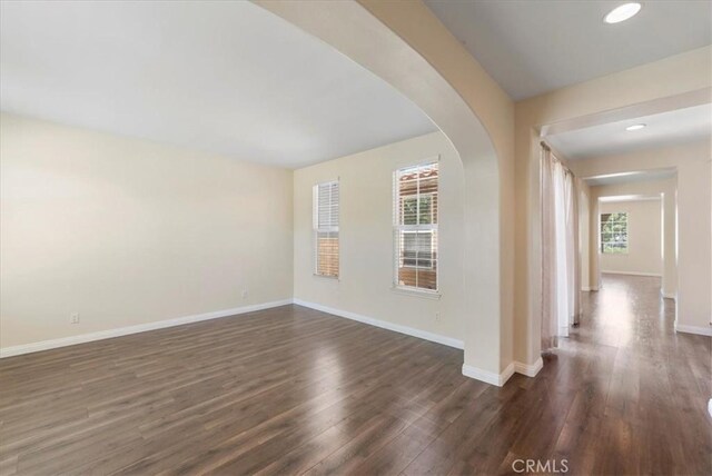 27020 Island Rd, Valencia, CA 91355 - unfurnished room featuring dark wood-style flooring, arched walkways, and recessed lighting