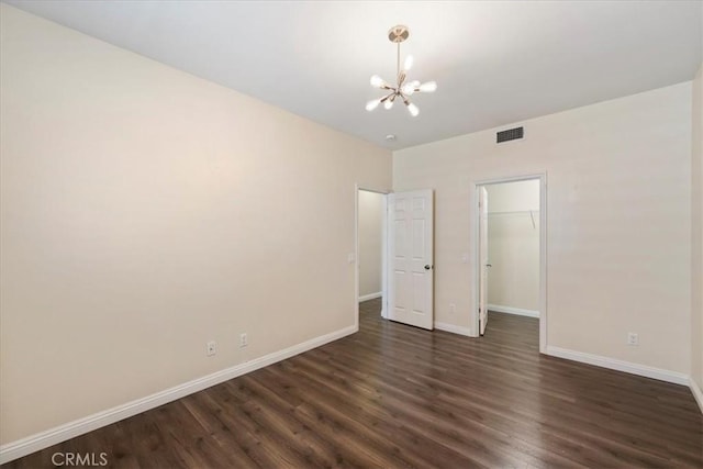 27020 Island Rd, Valencia, CA 91355 - unfurnished bedroom with a chandelier, dark wood-style flooring, a spacious closet, and a closet