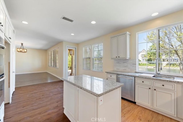 27020 Island Rd, Valencia, CA 91355 - kitchen with stainless steel dishwasher, plenty of natural light, light wood-type flooring, a kitchen island, and recessed lighting