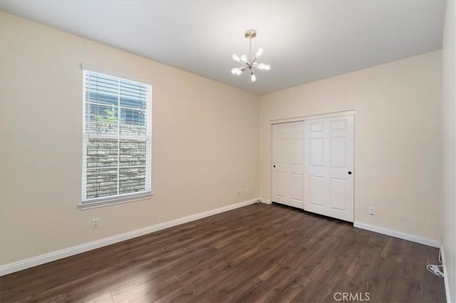 27020 Island Rd, Valencia, CA 91355 - unfurnished bedroom featuring dark wood-style flooring, a chandelier, and a closet