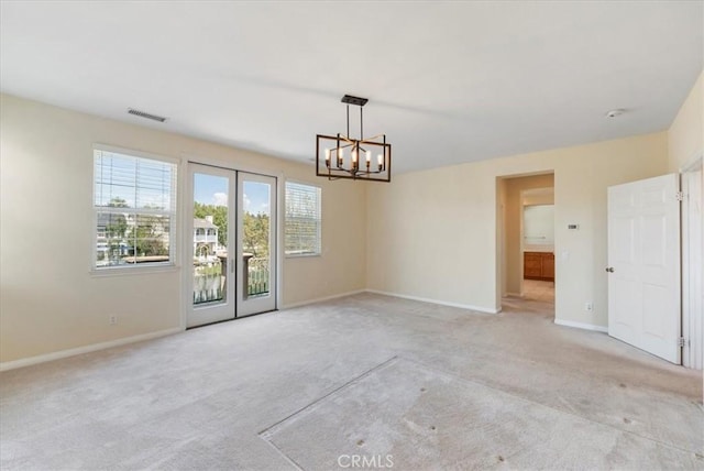 27020 Island Rd, Valencia, CA 91355 - unfurnished dining area featuring light carpet, a chandelier, and french doors