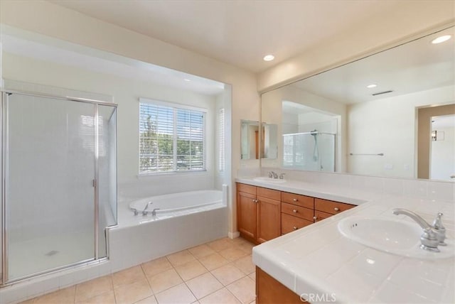 27020 Island Rd, Valencia, CA 91355 - full bathroom with double vanity, a garden tub, a stall shower, tile patterned flooring, and recessed lighting