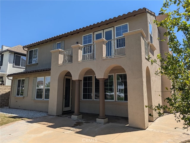 27020 Island Rd, Valencia, CA 91355 - view of front of home featuring a balcony, stucco siding, and a patio area