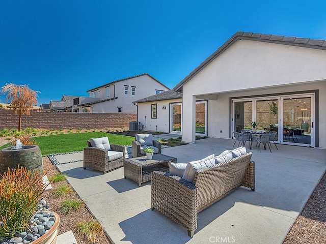 view of patio featuring central air condition unit, fence, and an outdoor hangout area