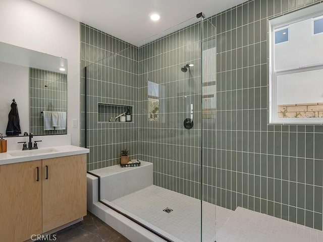 bathroom with vanity, marble finish floor, a walk in shower, and recessed lighting