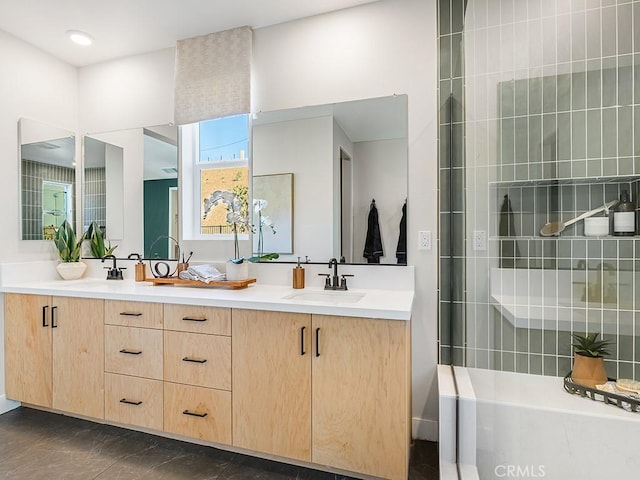full bath with double vanity, walk in shower, a sink, and marble finish floor