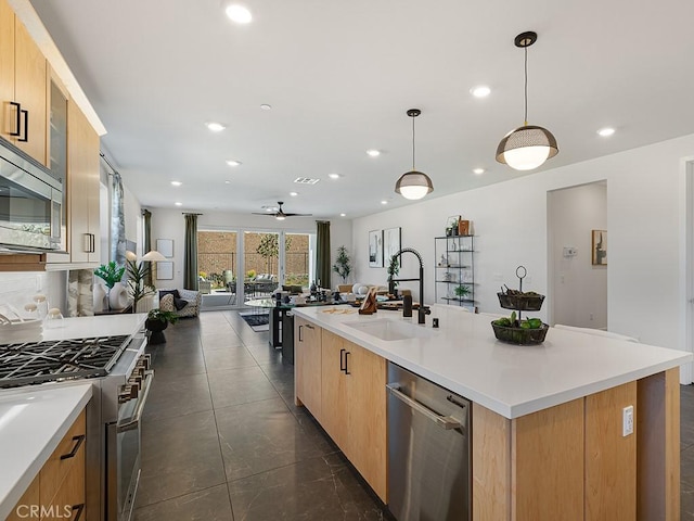 kitchen featuring a sink, appliances with stainless steel finishes, ceiling fan, and recessed lighting