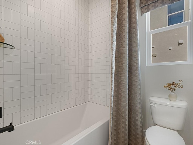 bathroom featuring shower / bathtub combination with curtain and toilet