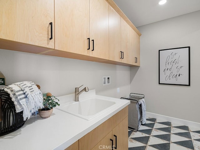 laundry area featuring cabinet space, washer hookup, a sink, recessed lighting, and baseboards