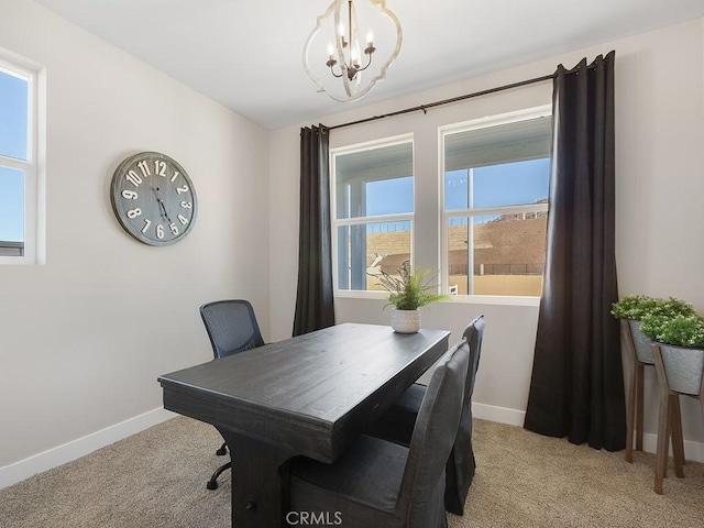 interior space featuring a chandelier, baseboards, and light colored carpet