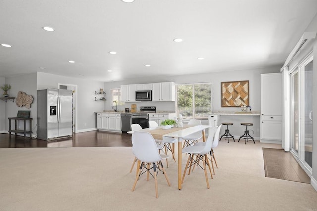 dining space with carpet floors, recessed lighting, and baseboards