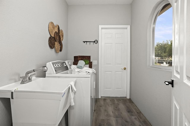 laundry room with plenty of natural light, laundry area, wood finished floors, a sink, and washer and clothes dryer