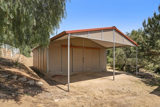 view of outbuilding with a carport