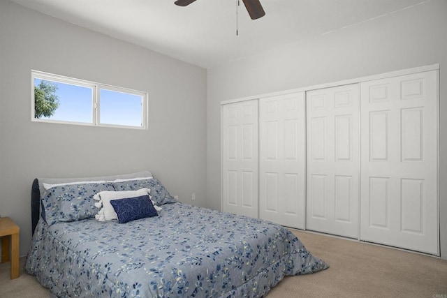 carpeted bedroom featuring a closet and a ceiling fan