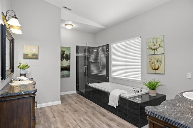 bathroom with visible vents, a garden tub, vanity, lofted ceiling, and a stall shower
