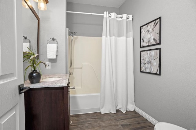 full bath with vanity, wood finished floors, shower / bath combination with curtain, and toilet